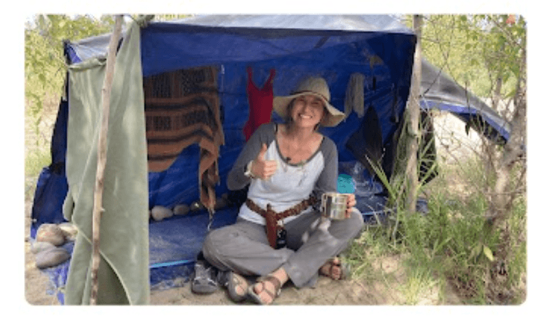 Student relaxing at camp shelter